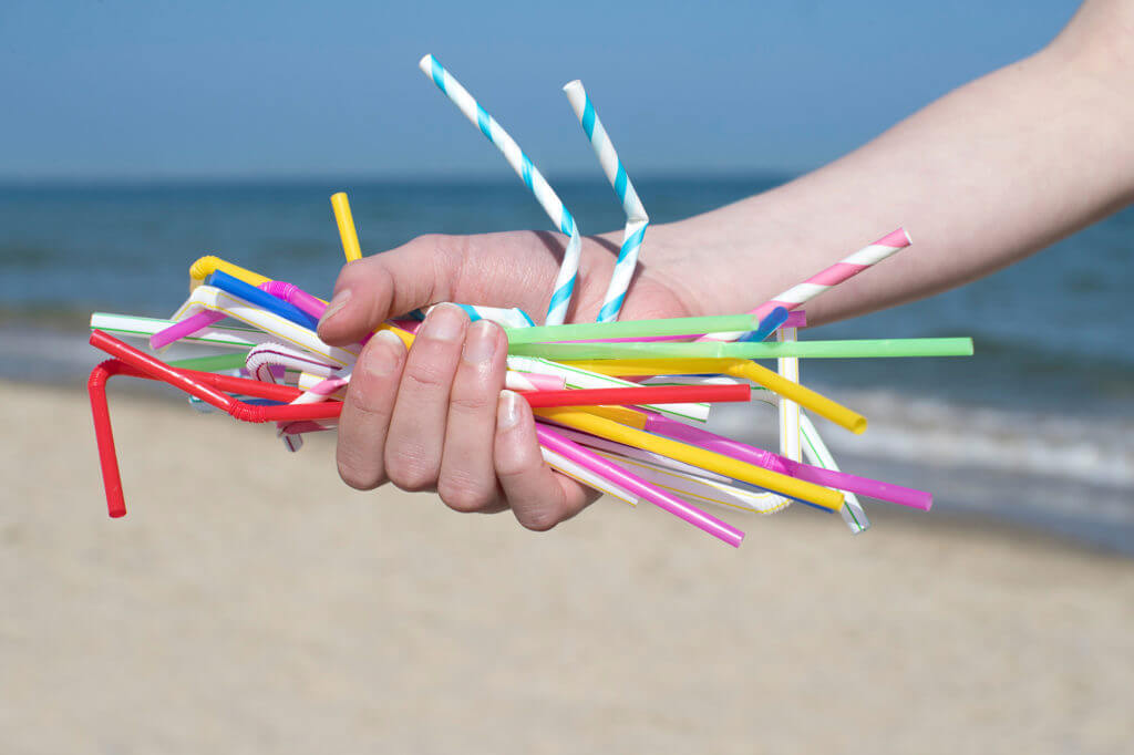 Hand holding many straws